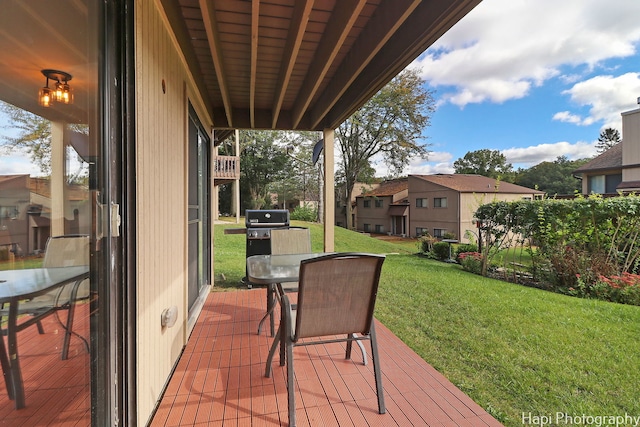 wooden terrace featuring a yard and grilling area