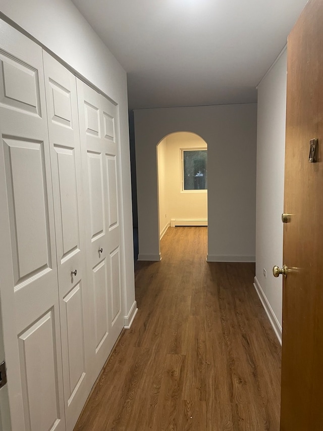 hall featuring dark hardwood / wood-style flooring and a baseboard heating unit