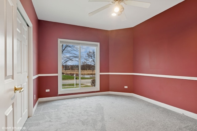 empty room with carpet and ceiling fan