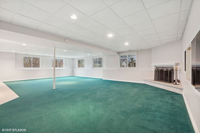 interior space featuring carpet flooring and a drop ceiling