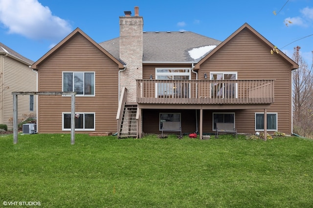 rear view of property featuring a yard, a wooden deck, and central AC