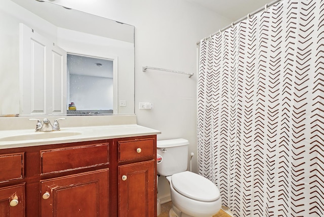 bathroom with walk in shower, vanity, and toilet