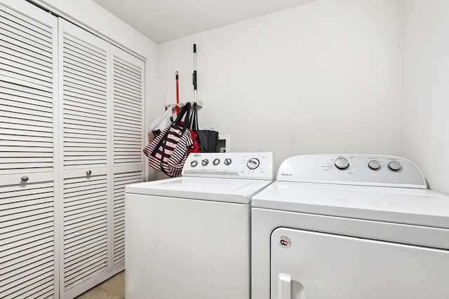 washroom with washing machine and dryer and light tile patterned floors