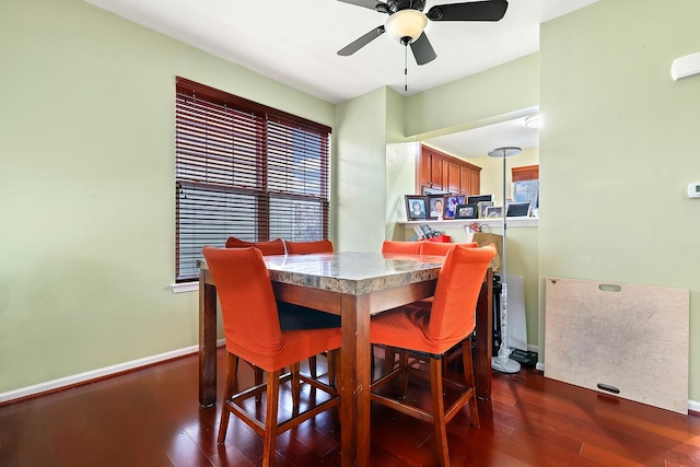 dining room featuring dark hardwood / wood-style flooring, ceiling fan, and a healthy amount of sunlight