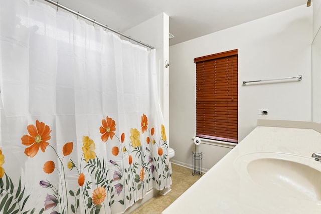 bathroom featuring tile patterned floors, vanity, and toilet