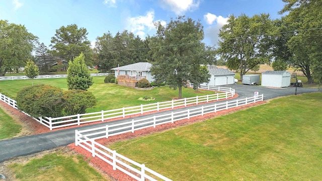 view of front facade with a front lawn and a shed