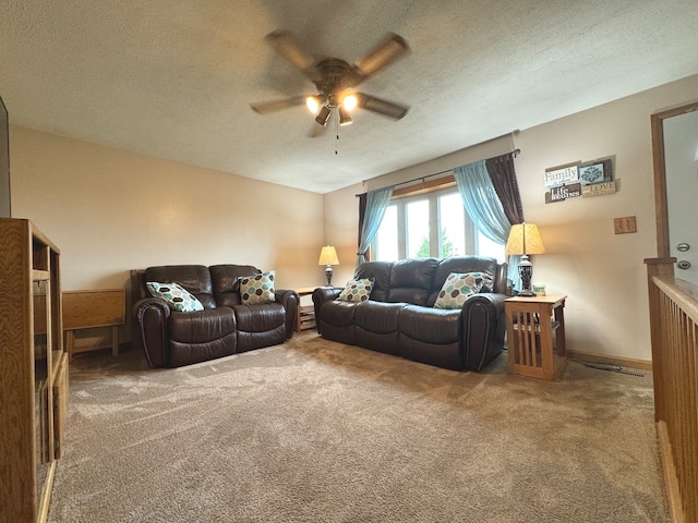 carpeted living room with a textured ceiling and ceiling fan