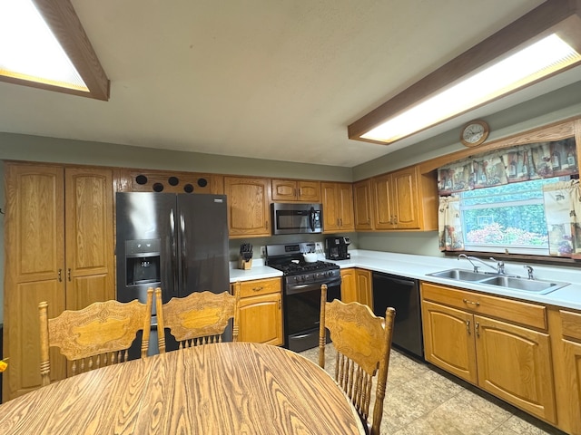 kitchen featuring black appliances, sink, and plenty of natural light