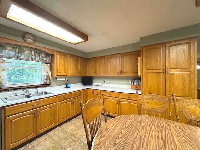 kitchen with light tile patterned floors and sink