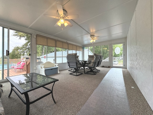 sunroom / solarium featuring ceiling fan and plenty of natural light