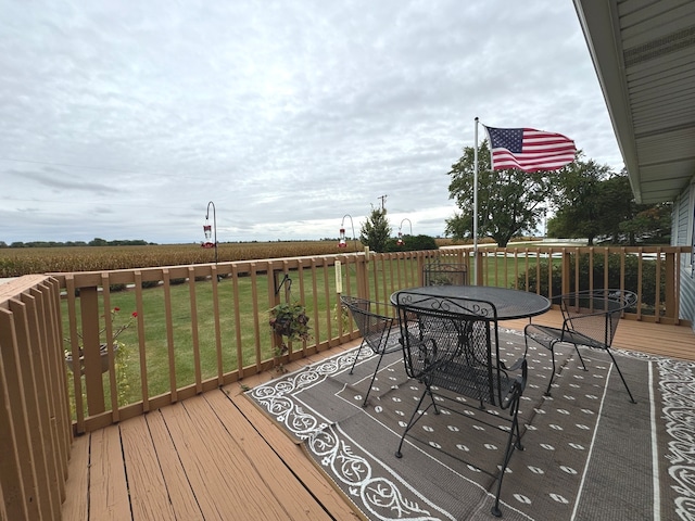 wooden terrace featuring a lawn