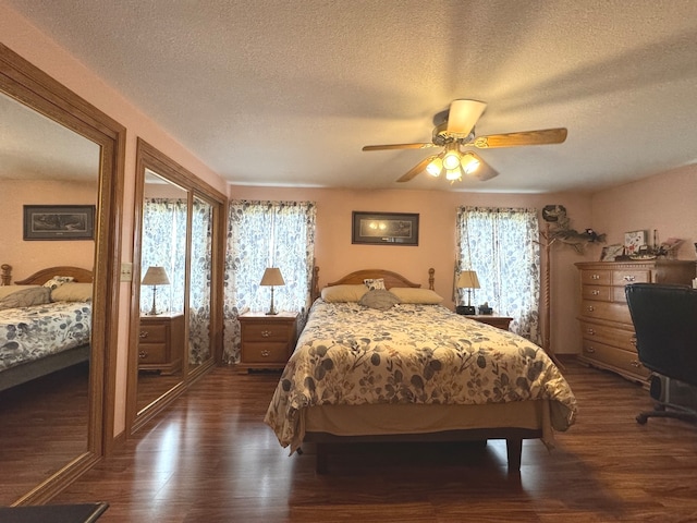 bedroom featuring multiple windows, a textured ceiling, dark wood-type flooring, and ceiling fan