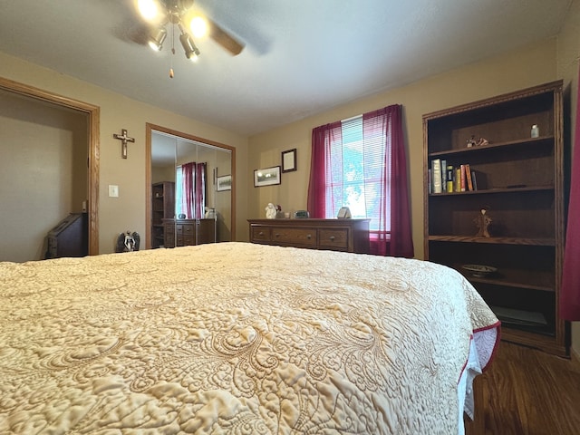 bedroom with a closet, ceiling fan, and dark hardwood / wood-style flooring