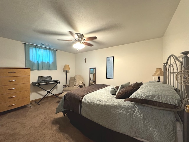 carpeted bedroom featuring ceiling fan and a textured ceiling