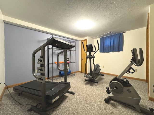 exercise room with a textured ceiling and carpet flooring