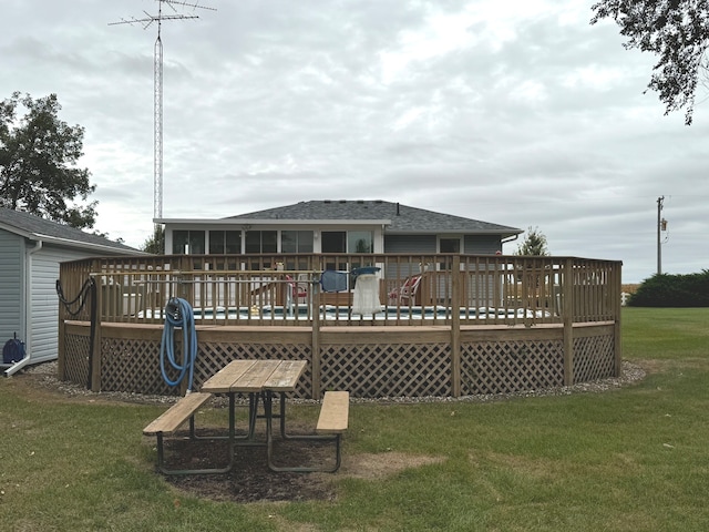 back of house with a lawn and a wooden deck