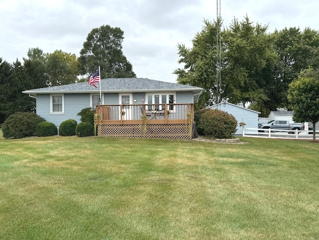 back of house featuring a lawn and a wooden deck