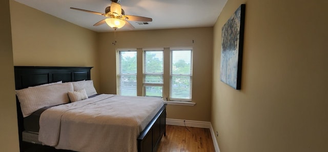 bedroom with ceiling fan and wood-type flooring