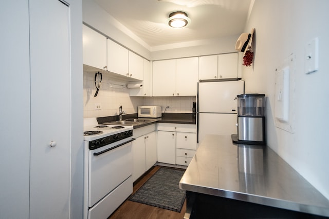 kitchen featuring stainless steel counters, white cabinets, and white appliances