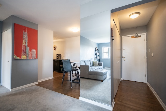 interior space with dark hardwood / wood-style floors and a baseboard heating unit