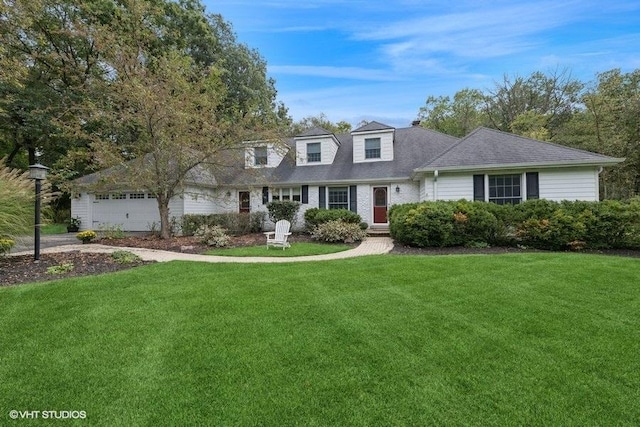 new england style home with a garage and a front yard