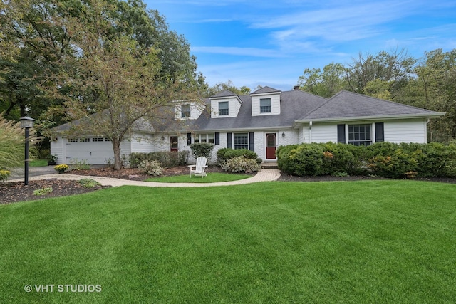 cape cod house featuring a front yard and a garage