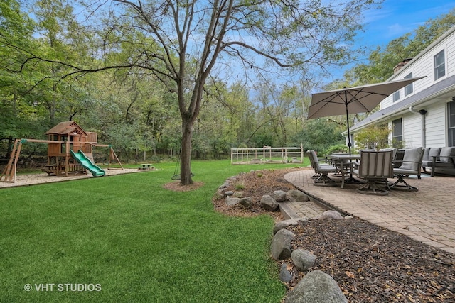 view of yard featuring a playground and a patio area