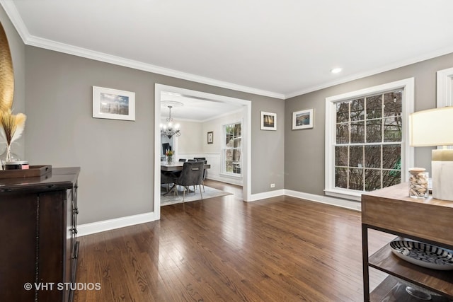 interior space featuring dark hardwood / wood-style flooring, crown molding, and a chandelier