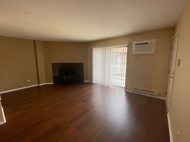 unfurnished living room featuring a baseboard radiator, a wall mounted air conditioner, and dark hardwood / wood-style flooring