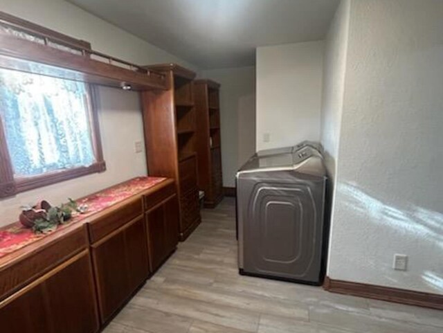 clothes washing area with light hardwood / wood-style floors