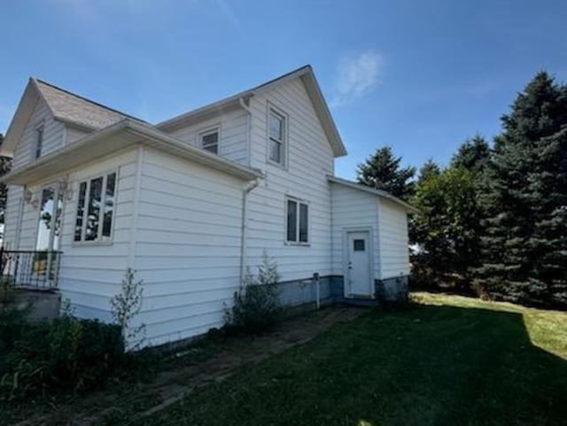 view of property exterior with a yard