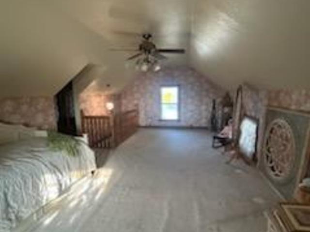 bedroom with ceiling fan and lofted ceiling