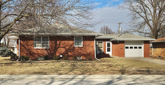 ranch-style house featuring driveway, brick siding, an attached garage, and a front yard