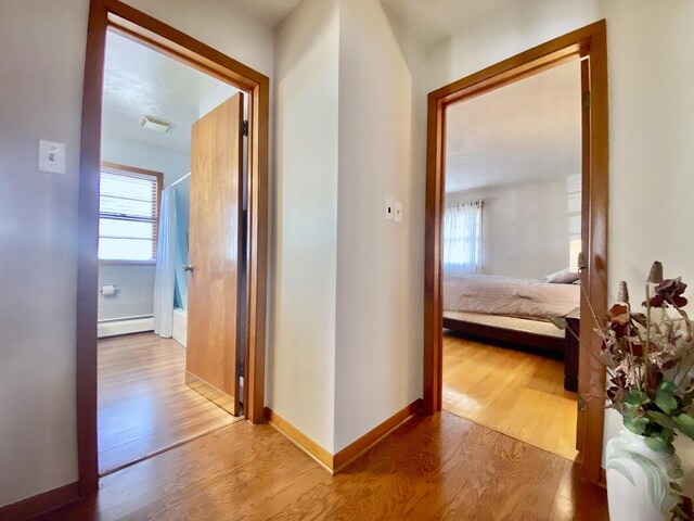 sitting room with hardwood / wood-style floors and crown molding