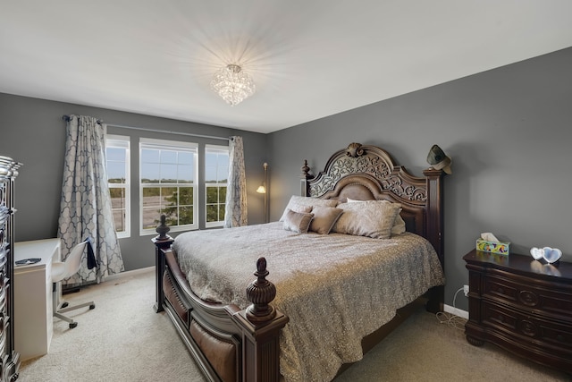 carpeted bedroom with a notable chandelier