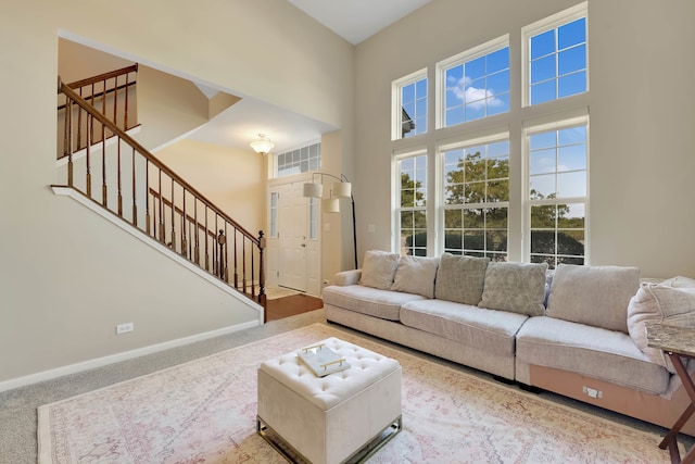 living room featuring carpet and a high ceiling