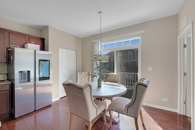 dining area with wood-type flooring