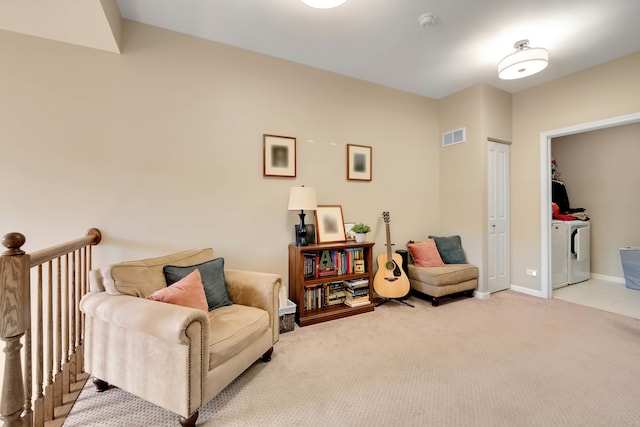 sitting room with light carpet and separate washer and dryer