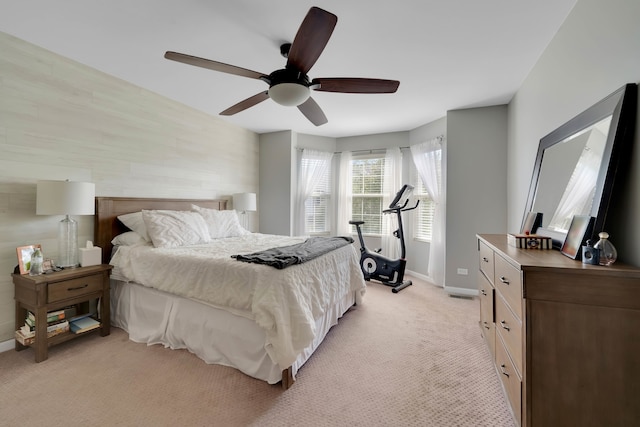 bedroom with ceiling fan and light carpet