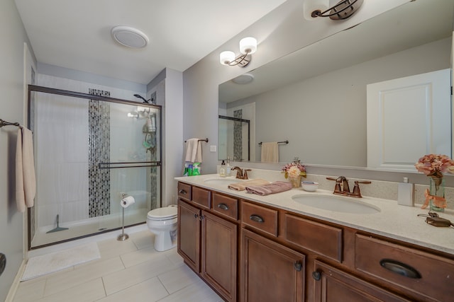 bathroom featuring walk in shower, vanity, tile patterned flooring, and toilet