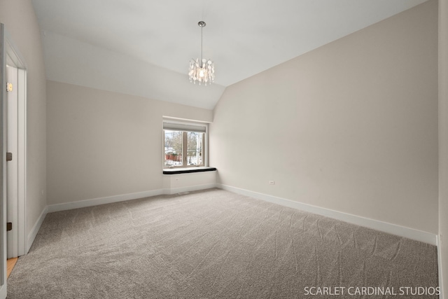 empty room featuring an inviting chandelier, lofted ceiling, and carpet