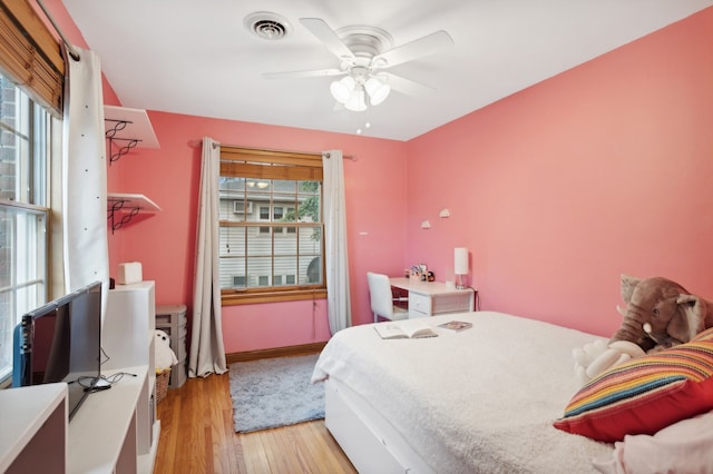 bedroom with ceiling fan and light hardwood / wood-style floors