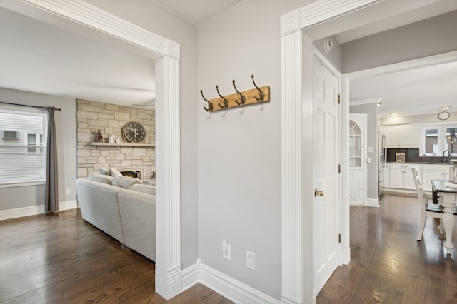 hallway with dark wood-type flooring and sink