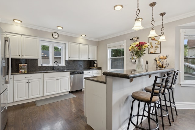 kitchen with white cabinetry, appliances with stainless steel finishes, and plenty of natural light