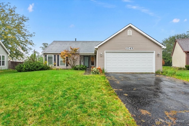 view of front of home featuring a front yard and a garage