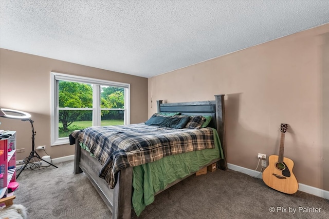 carpeted bedroom featuring a textured ceiling