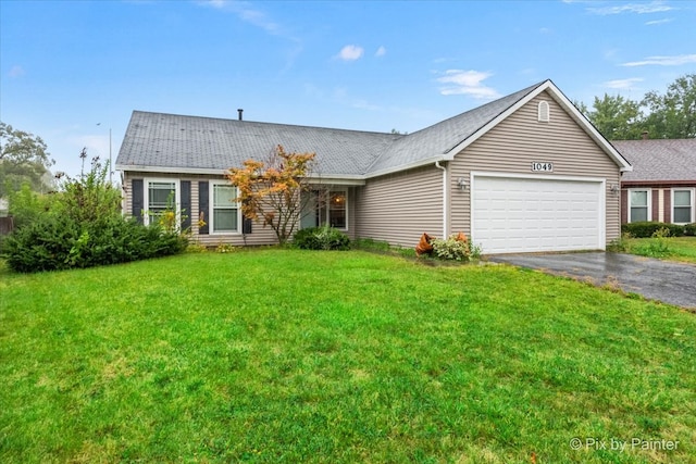 single story home with a front yard and a garage