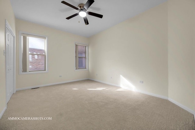 carpeted empty room featuring ceiling fan