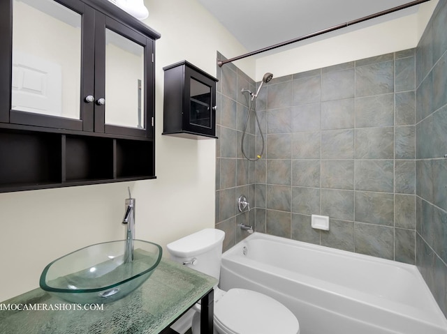 full bathroom featuring sink, toilet, and tiled shower / bath