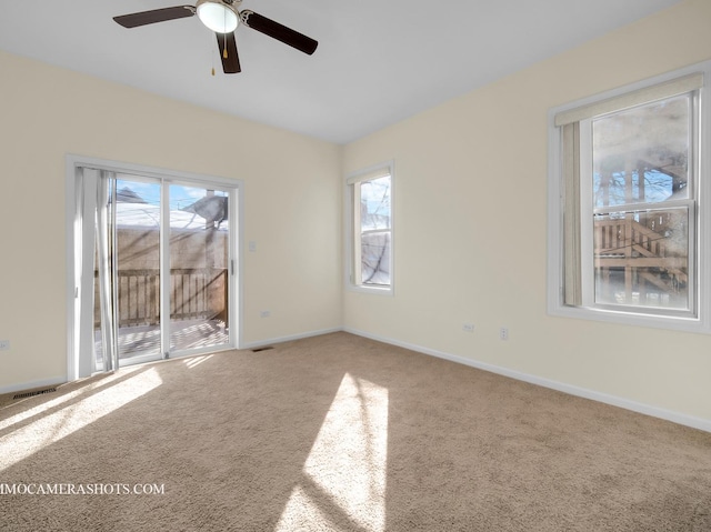 empty room featuring carpet flooring and ceiling fan